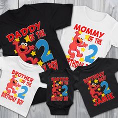 three matching shirts with the number two, one for each child's first birthday