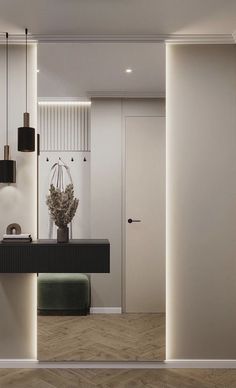 a modern bathroom with white walls and wood flooring, along with black counter tops