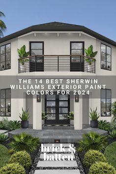 the front view of a two story house with black shutters and plants on either side