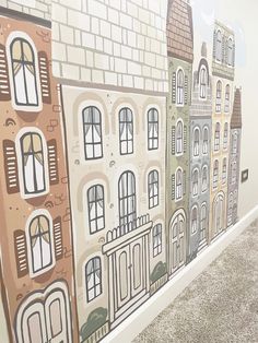 there is a mural on the side of this building that has windows and buildings painted on it