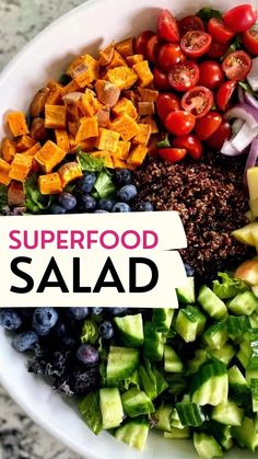 a bowl filled with different types of food and the words superfood salad above it