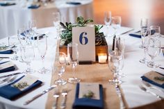 the table is set with place cards and silverware