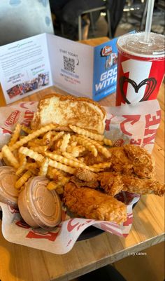 fried chicken, french fries and soda on a table