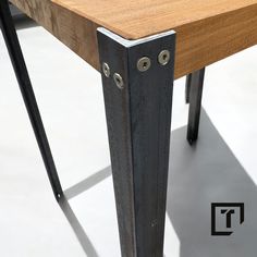 a wooden table with metal legs on it