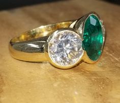 Gorgeous vintage 18K yellow gold engagement three stones ring Gem green Colombia emerald. Center set treated green Colombia emerald in round shape weight 4.63ct. size 11.8mm very nice rich vivid green color nice luster, lively ,nice cut,Sparkly emerald and clean. side set 2 natural white sapphire round shape total weight 5.65ct. Size 9mm Gorgeous setting ring solid gold Ring size 7.5 Resizable Retail Value $12,500 net. Appraisal available Three Stone Engagement Rings Round, Platinum Engagement Rings Vintage, Engagement Ring Round, Filigree Engagement Ring, Engagement Rings Round, Round Diamond Engagement Rings, Yellow Gold Engagement, Three Stone Engagement, Three Stone Engagement Rings