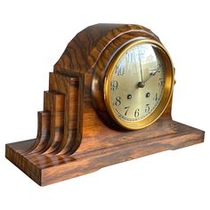 a wooden clock sitting on top of three pieces of wood