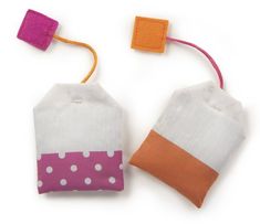 two small bags with different colored handles on each one and an orange string attached to them