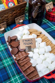 a tray filled with marshmallows, chocolate chips and s'mores