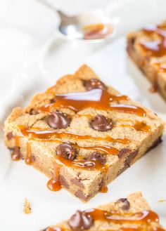 two pieces of chocolate chip cookie bars with caramel drizzled on top