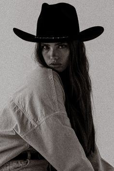 a woman with long hair wearing a cowboy hat