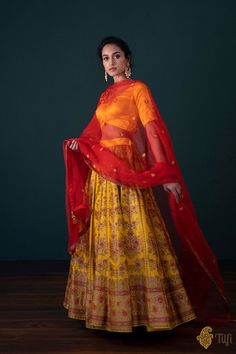 "Nargis\nAn exquisite handloom lehenga in a festive combination of hues. A labour of love, encapsulating\u00a0centuries of weaving traditions and months\u00a0of painstaking craftsmanship.\u00a0On your special day,\u00a0wrap yourself in these yards of our heritage.\n\u00a0\n\n\nColor\u00a0- A\u00a0happy and auspicious\u00a0shade of\u00a0Yellow\n\nFabric\u00a0- Lehenga in Pure Katan silk, blouse in pure Satin Silk and\u00a0dupatta in pure Silk Organza\u00a0\n\nSpeciality\u00a0-\u00a0This beautiful lehenga\u00a0is handwoven in classic\u00a0antique zari\u00a0with delicate meenakari detailing in Red. The odhani is in a beautiful complimentary red with\u00a0painstaking aari hand-embroidery\u00a0all across its borders and bootis. Completed with a lustrous satin blouse with dainty embroidery and a Handloom Lehenga, Banarasi Lehengas, Katan Silk, Satin Blouse, Silk Organza, Yellow Fabric, India Fashion, Shades Of Yellow, Labour