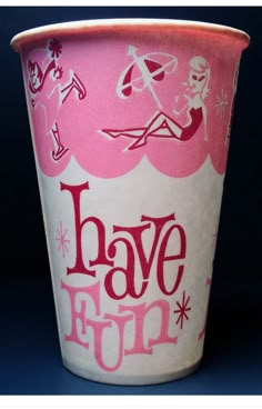 a pink and white cup with the words have fun written in red ink on it