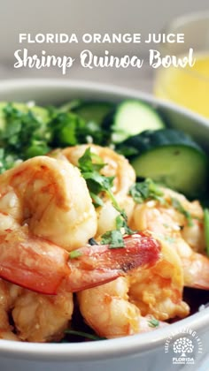 a bowl filled with shrimp and veggies next to a glass of orange juice