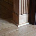 the corner of a room with wood flooring