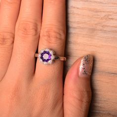 It is a natural amethyst ring. The main stone is 7 mm*7 mm round cut.weight about 1.25 carats. The basic metal is sterling silver and plated with rhodium. To change the metal to a solid gold (white/rose) or platinum is also available, please ask for a quotation if you want. You can also go to my shop Home for more elegant rings: https://www.etsy.com/shop/godjewelry?ref=hdr_shop_menu Amethyst is February birthstone More amethyst rings: https://www.etsy.com/shop/godjewelry?ref=seller-platform-mcna Purple Birthstone Ring With Bezel Setting For Anniversary, Purple Bezel Set Birthstone Ring For Weddings, Classic Purple Sapphire Ring, Sterling Silver Amethyst Ring With Prong Setting For Promise, Silver Amethyst Birthstone Ring With Bezel Setting, Promise Amethyst Ring With Prong Setting In Silver, Amethyst Rings With Bezel Setting For Promise, Purple Sapphire Ring With Bezel Setting As Gift, Purple Sterling Silver Birthstone Ring With Round Band