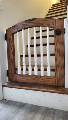 a wooden bannister with white railings and wood hand rails on the stairs