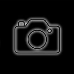 an image of a camera on a black background with the light coming from it's lens