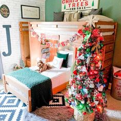 a bedroom decorated for christmas with a teddy bear on the bed and a tree in the corner