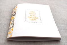 an open notebook with the words don't forget to be awesome today