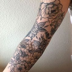 a woman's arm with flowers on it