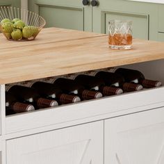 a wooden counter top with wine bottles in it