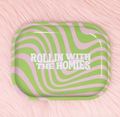 the rolling with the homies logo is on a green and pink striped plastic tray