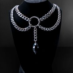 This elusive statement piece necklace features the ever coveted chunky cuban chain with curb chain draped accents that perfectly complement the elongated oval jewel. Each element of this design connect to a centralized O ring that flawlessly completes the look. Bewitching, classy, bold, and elegant; this design pairs well with a variety of styles. Specifications: ✌️Handmade item 🪙Materials: Stainless steel, Acrylic  🔗Chain Type: Cuban link choker with curb chain accents 📏Choker Size: 12 inche Black Punk Jewelry With Chunky Chain, Edgy Metal Jewelry With Chunky Chain, Punk Metal Chunky Chain Jewelry, Metal Jewelry With Chain Strap And Cuban Link, Gothic Metal Jewelry With Chain Strap, Silver Gothic Jewelry With Chunky Chain, Gothic Silver Jewelry With Chunky Chain, Silver Gothic Chunky Chain Jewelry, Edgy Double Chain Link Necklace