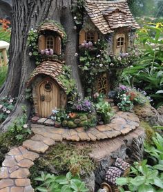 a fairy garden with a tree and house