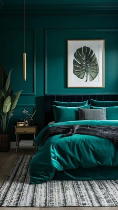 a bed with green sheets and pillows in a room that is painted dark teal