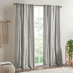 a living room with white and gray curtains