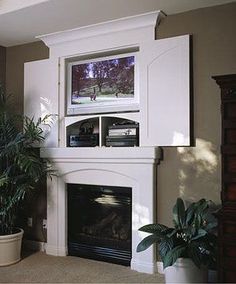 a living room filled with furniture and a fire place under a flat screen tv mounted above a fireplace