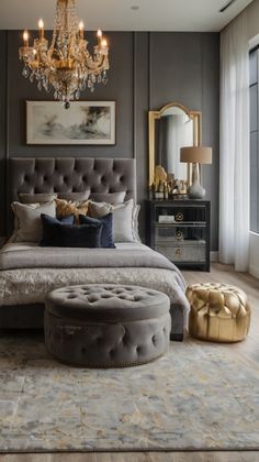 a bedroom with a large bed, chandelier and two stools in front of it