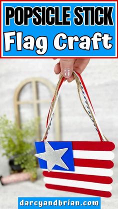 a hand holding a red, white and blue flag craft with text overlay that reads popsicle stick flag craft