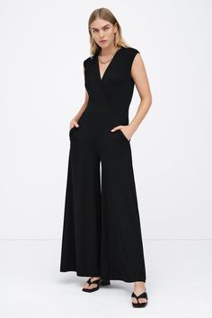 Our Davis Jumpsuit is effortlessly chic from head to toe. Her sleeveless top features slightly dropped shoulders and dips into an overlapped v-neckline, while her flowy wide-leg pants offer everybody's favorite utilitarian detail: pockets. From ultra-soft European jersey, Davis is a sleek fit that takes you from morning subway commutes to drinks after hours in style.[SPLIT] Maritza is 5'9" (177 cm) tall, wearing size XS. Approximately 56.5" (144 cm), measured from the shoulder to the bottom hem. Sustainable European Jersey (96% Tencel, 4% Elastane). Machine wash on delicate cycle, or hand wash in cold water. Tumble dry on low heat, or for best results, lay flat to dry. Designed in NYC. Handcrafted in Europe. Our production team enjoys a living wage, a 40-hour work week with paid overtime, Elegant V-neck Elastane Jumpsuits And Rompers, Versatile Fitted V-neck Jumpsuits And Rompers, Versatile Fitted V-neck Jumpsuit, Chic V-neck Elastane Jumpsuits And Rompers, V-neck Elastane Jumpsuit For Work, Stretch Elastane V-neck Jumpsuits And Rompers, Elegant V-neck Elastane Jumpsuit Or Romper, Versatile Black V-neck Jumpsuits And Rompers, Chic Fitted Jumpsuits And Rompers With Surplice Neckline