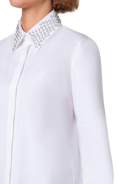 Faceted, round-cut rhinestones pattern the removable point collar on this crisp button-up shirt tailored with a hidden placket and back pleat. Hidden-button placket Band collar; removable point collar Long sleeves with button cuffs Side slits Drop-tail hem 100% cotton Dry clean Imported Designer Clothing Elegant Embellished Workwear Shirt, Embellished Button-up Workwear Blouse, Elegant Button-up Embellished Blouse, Elegant Embellished Button-up Blouse, Embellished Fitted Shirt For Workwear, Luxury Tops With Embellished Collar, Elegant Long Sleeve Shirt With Embellished Collar, Luxury Formal Tops With Embellished Collar, Luxury Tops With Embellished Collar For Formal Occasions