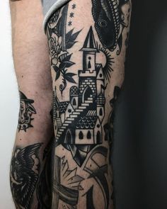 a man's leg with tattoos on it and an image of a castle in the background