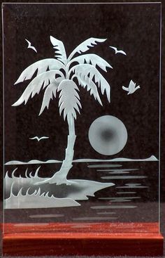 an etched glass plaque depicting a palm tree