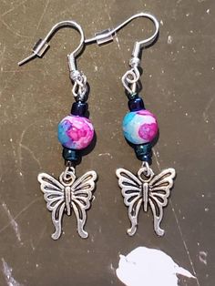 "These beautiful butterflies are sure to make you smile! Watercolor floral and black rainbow beads add the perfect touch. Approximately 2\" long including the fish hook posts." Multicolor Butterfly Earrings, Adjustable Multicolor Whimsical Flower Earrings, Multicolor Butterfly Charm Earrings, Bohemian Adjustable Butterfly Earrings, Trendy Jewelry Ideas, Acrylic Nails Almond Shape, Diy Earrings Easy, Watercolor Butterfly, Diy Jewelry Unique