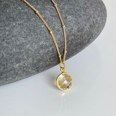 Yellow Topaz Necklace, Light Yellow Round Pendant Bezeled in Gold Filled, November Birthstone, Satellite Chain Layering Jewelry Gift for Mom This luminous but simple necklace features a faceted Yellow Topaz round shape pendant bezeled in gold filled. The eye catching light soft canary yellow pendant is suspended from a dainty satellite ball chain in gold filled. Perfect every day jewelry that just pops while being understated.  Ideal layering statement yet simple necklace, very vibrant and a won Gold Birthstone Crystal Necklace, Topaz Jewelry November, Yellow Pendant, Chain Layering, Topaz Birthstone, Layering Jewelry, Topaz Jewelry, Topaz Necklace, Canary Yellow