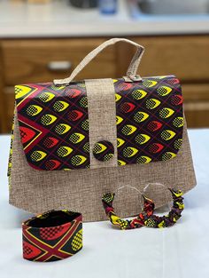 Handbag made with African fabric comes with a pair of earrings and a bracelet. A Perfect gift for mothers day. Multicolor Bags For Mother's Day Gift, Mother's Day Multicolor Bags As Gift, Mother's Day Gift Multicolor Bags, Beige Fabric Bag As A Gift, Beige Fabric Bag For Gift, Beige Fabric Bag Gift, Casual Fabric Shoulder Bag As Gift, Red Adjustable Bags For Gifts, Rectangular Fabric Shoulder Bag As Gift