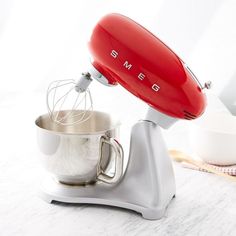 an electric mixer sitting on top of a table