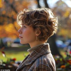 a close up of a person with short hair wearing a jacket and looking off into the distance