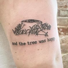 a man with a tattoo on his arm that says and the tree was happy,