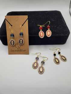 These earrings feature Our Lady of Guadalupe beads and sparkling crystal accents. The earrings are French hooks and stainless steel in a gold tone. Gold Jeweled Beaded Drop Earrings, Gold Jeweled Beaded Dangle Earrings, Jeweled Earrings As Gift, Catholic Earrings, Our Lady Of Guadalupe, Lady Of Guadalupe, Tassel Drop Earrings, Shell Earrings, Sparkling Crystal