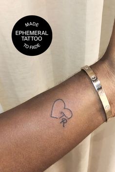 a woman's arm with a tattoo on it that says made ephemeral tattoo to fade