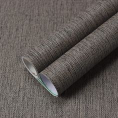 a roll of grey fabric on top of a table