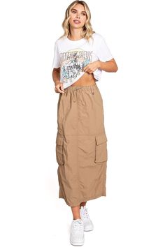 Chic, parachute skirt with an elastic waistband, a drawstring cinch tie and cargo pockets down the sides. Pair it with a graphic tee and sneakers for an effortless streetwear look. CARE | Machine Wash Cold CONTENTS | 100% Nylon MEASUREMENTS | 33"/85 cm Top to Bottom (Size Small) MODEL | 5'8 - wearing a size Small IMPORTED Casual Drawstring Cargo Skirt For Summer, Casual Cargo Skirt With Drawstring For Summer, Casual Summer Cargo Skirt With Drawstring, Spring Utility Cargo Skirt With Drawstring, Casual Summer Cargo Skirt, Casual Parachute Pants For Spring Outdoor Activities, Summer Utility Cargo Skirt With Drawstring, Casual Spring Cargo Skirt With Pockets, Casual Summer Cargo Skirt With Side Pockets