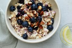 a bowl of oatmeal with blueberries and almonds