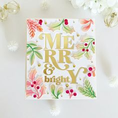 a card that says merry and is surrounded by flowers