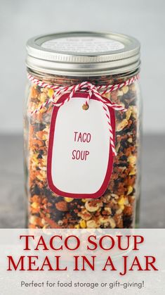 a jar filled with taco soup next to a tag that says taco soup meal in a jar